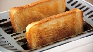 Two slices of toasted bread in a toaster. - Beach Street Motel Apartments (New Plymouth)