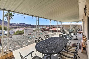 Enjoy dining or socializing under a covered patio with a mountain view.