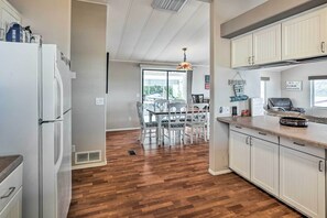 Enjoy meals in the kitchen with a central island and oven, and dine at the table with a chandelier above.