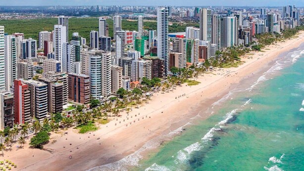 A coastal cityscape with high-rise buildings, a sandy beach, and a clear blue sea. - Apartment (Jaboatão dos Guararapes)