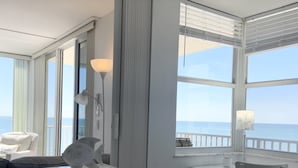 A room with a desk, chair, and a view of the ocean. - Direct beachfront! Best gulf views and sunsets! Pickleball and tennis!  (Fort Myers Beach)