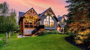 A large, modern house with a spacious front yard, a prominent staircase, and large windows. - The Mansion, Wasaga beach, Blue mountain (Utopia)