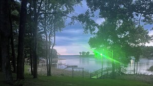 A park with a paved path, grassy areas, and a lake. - Quiet Cove with Big Water Views (Ridgeway)