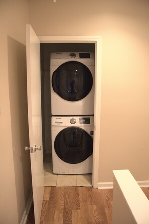 Convenient laundry facilities with two front-loading washing machines.