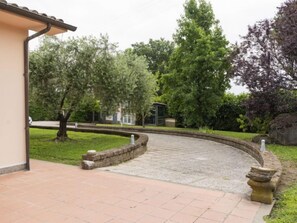Escape to a serene courtyard surrounded by lush greenery and a soothing fountain.
