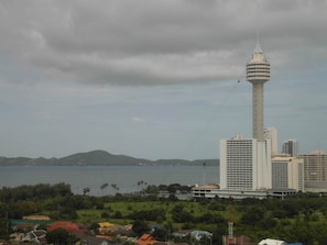 A coastal cityscape with a prominent tower and several high-rise buildings. - View Talay Vt1b F7 R348 (Pattaya)