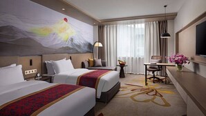 A hotel room with two beds, a desk, a chair, a TV, and a large abstract painting on the wall. - Ramada by Wyndham Daocheng (Garze)