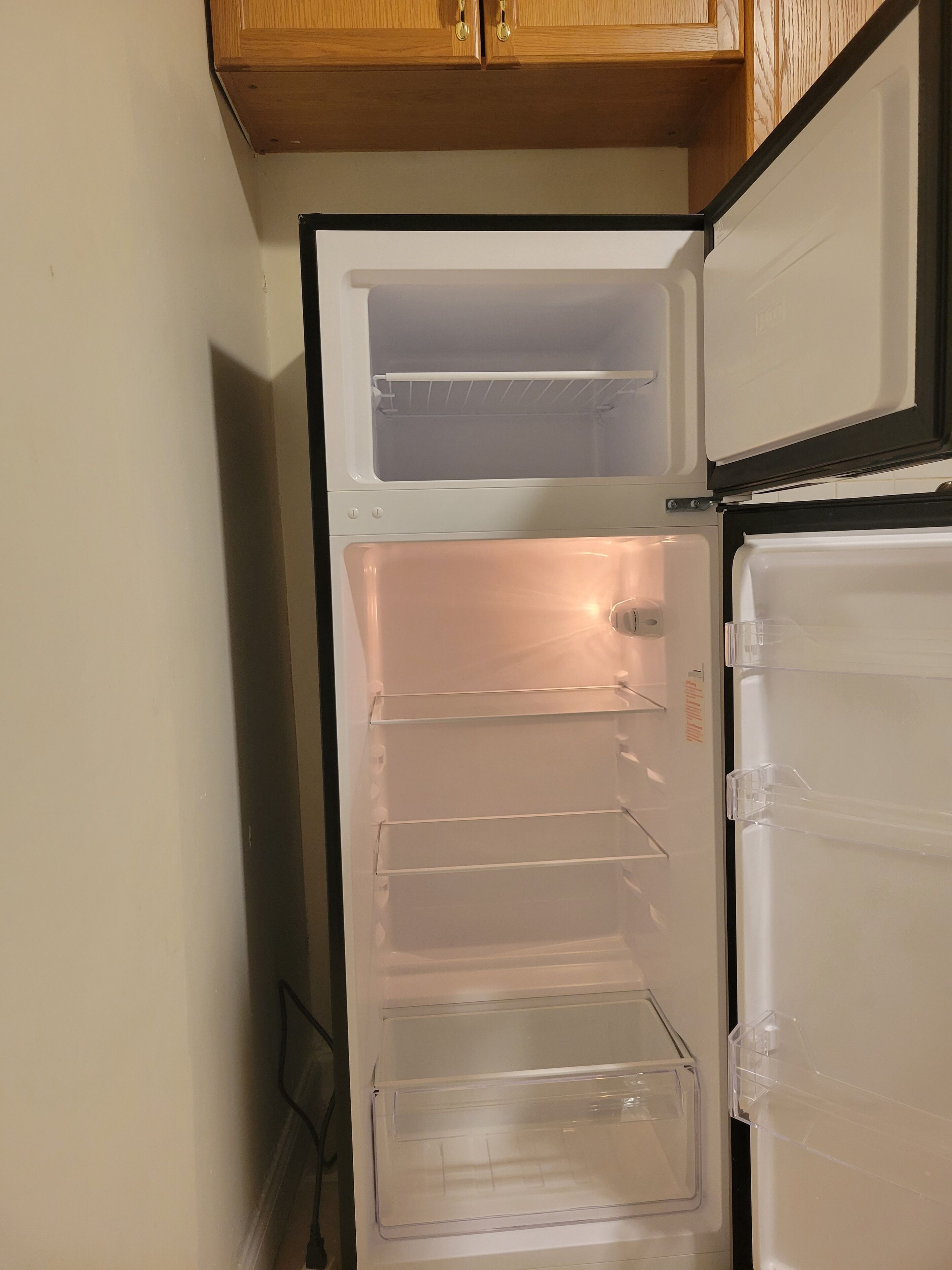 A refrigerator with multiple shelves and a freezer compartment.