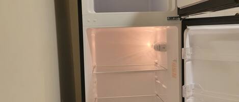 A refrigerator with multiple shelves and a freezer compartment.