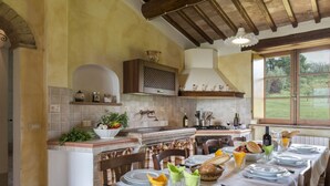 Una cucina rustica con zona pranzo apparecchiata per un pasto.