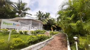 A tent labeled "Vegan Souls" with a sign stating "Right Food is Right Medicine." - Wanderlust Resort (Akola)