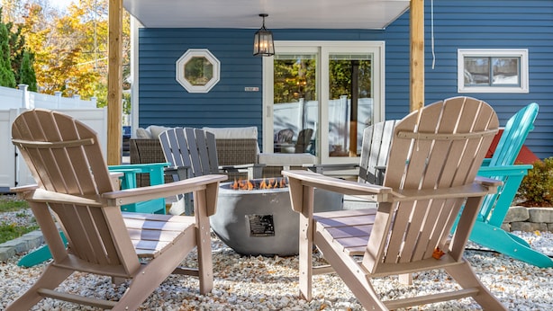 A covered patio area with Adirondack chairs, a fire pit, and a pergola. - DT Bar Harbor,2 King beds & Decks, Parks 3 small cars, Town Pickleball Ct @ Back (Bar Harbor)