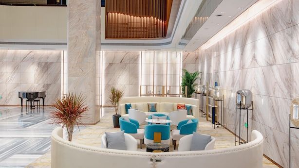 A modern lobby with a seating area, a piano, and a large column. - Holiday Inn Taiyuan City Center (Taiyuan)