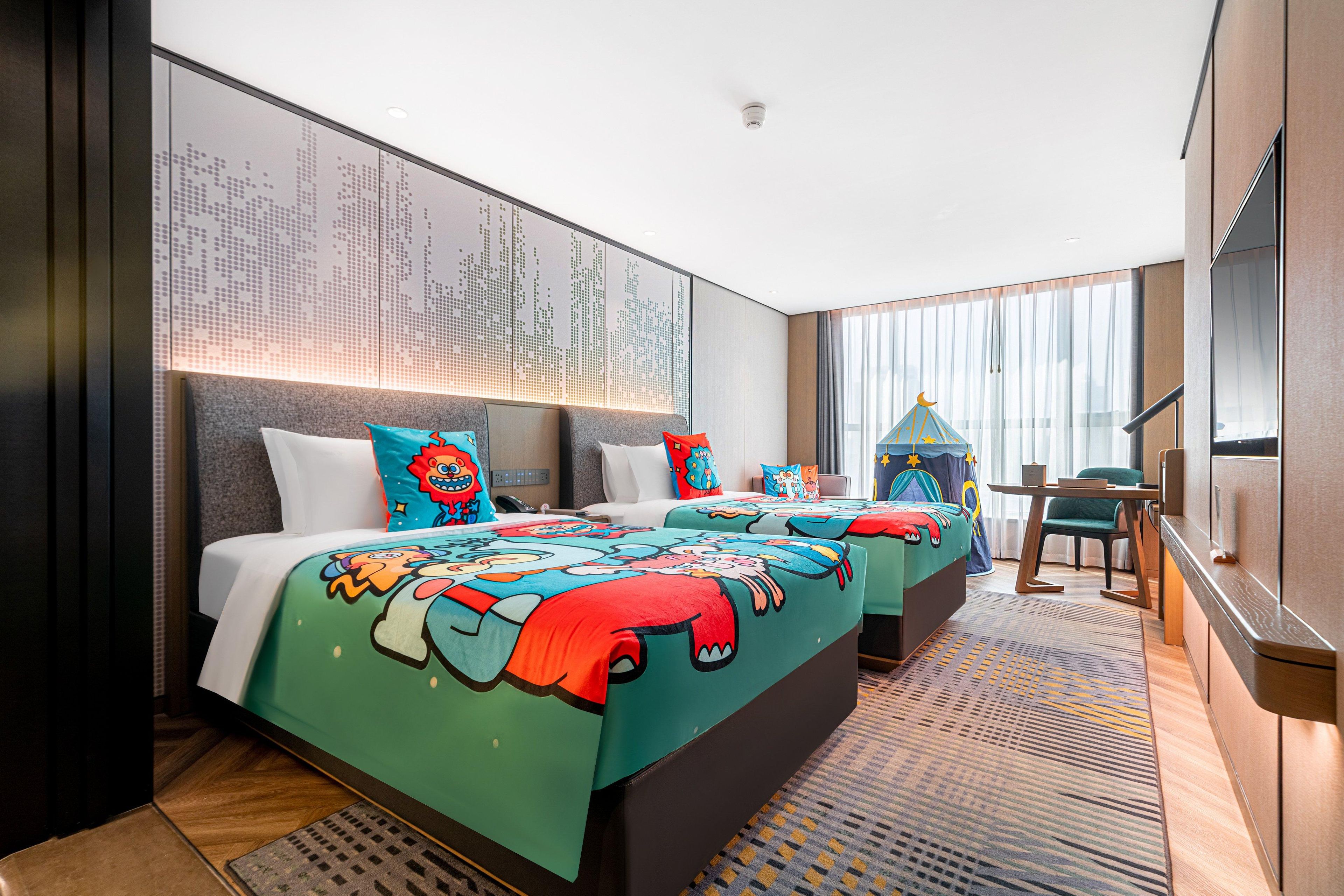 A hotel room with a large bed, a desk, a chair, and a large window.