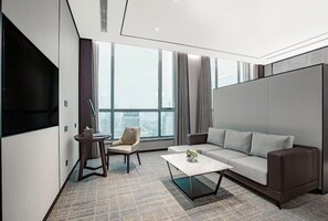 Enjoy city views from the large window, relax on the comfortable sofa, and unwind with a flat-screen TV.