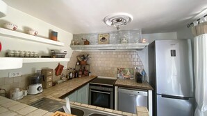 A kitchen with a Bosch dishwasher, a coffee maker, and a sink.