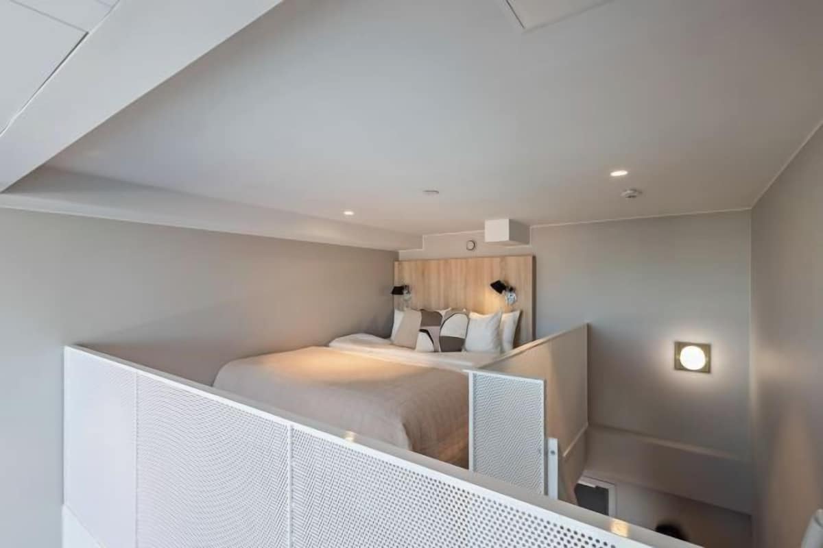 Premium bedding, desk, laptop workspace, blackout drapes