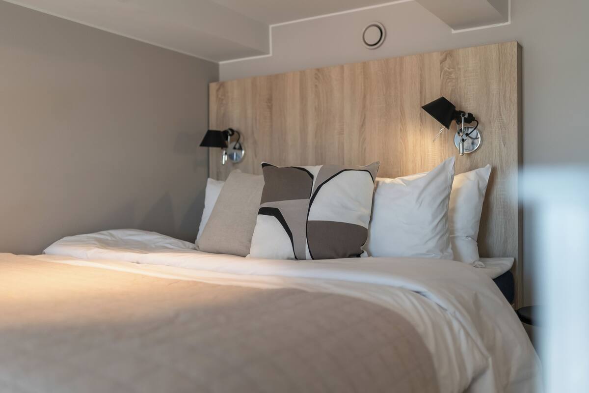 Premium bedding, desk, laptop workspace, blackout drapes