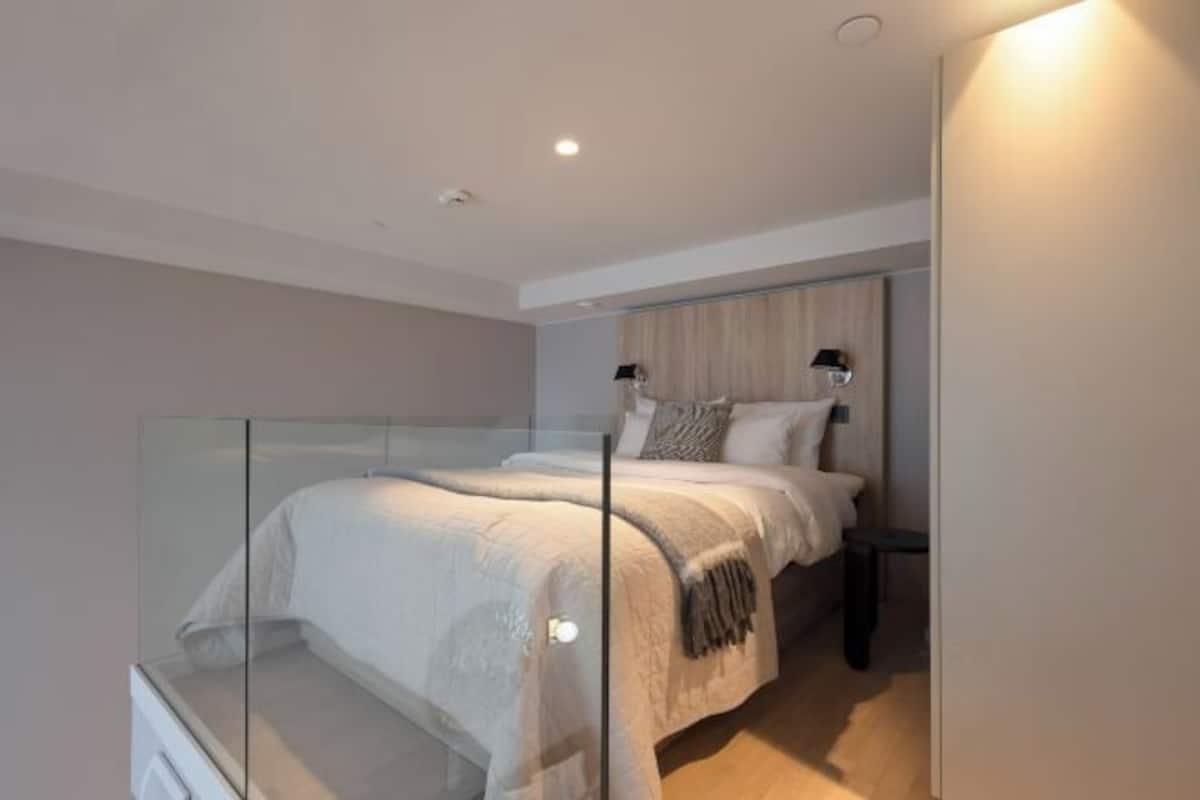 Premium bedding, desk, laptop workspace, blackout drapes