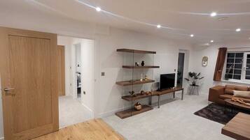 Deluxe Apartment | Living area | 55-inch flat-screen TV with cable channels, TV, offices