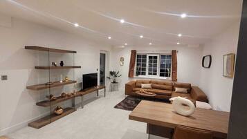 Deluxe Apartment | Living area | 55-inch flat-screen TV with cable channels, TV, offices