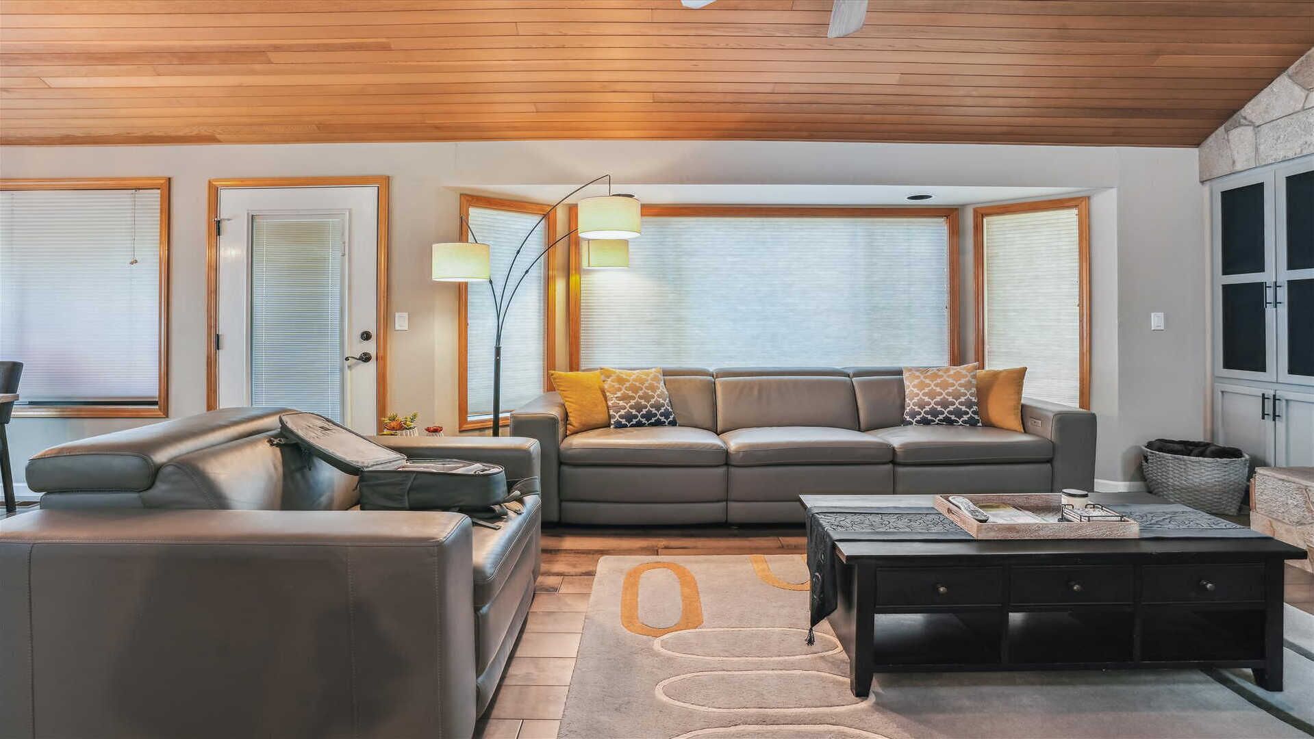 A modern living room with a sofa, a coffee table, and a lamp.