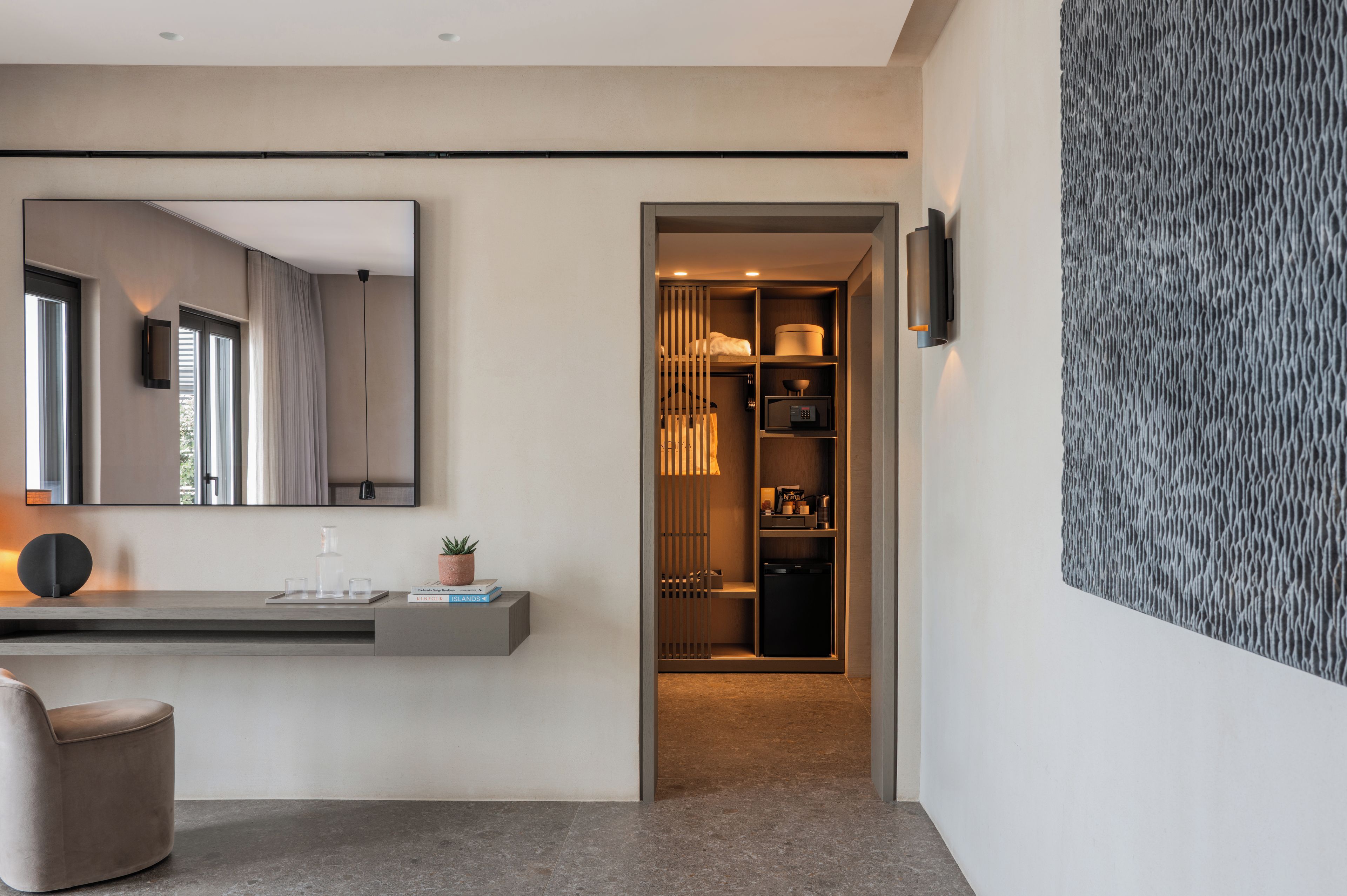 A modern bathroom with a large mirror, a vanity, and a shower area.