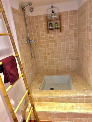 Chuveiro, toalhas de banho, sabonete, shampoo