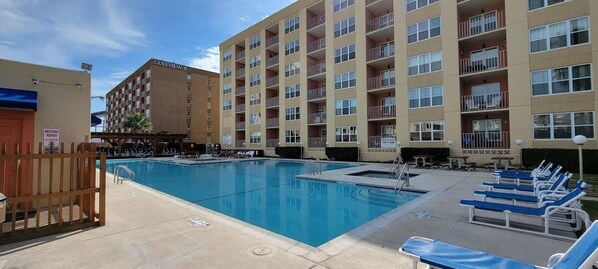 A swimming pool area with lounge chairs and a building labeled "Gulfview II" in the background.