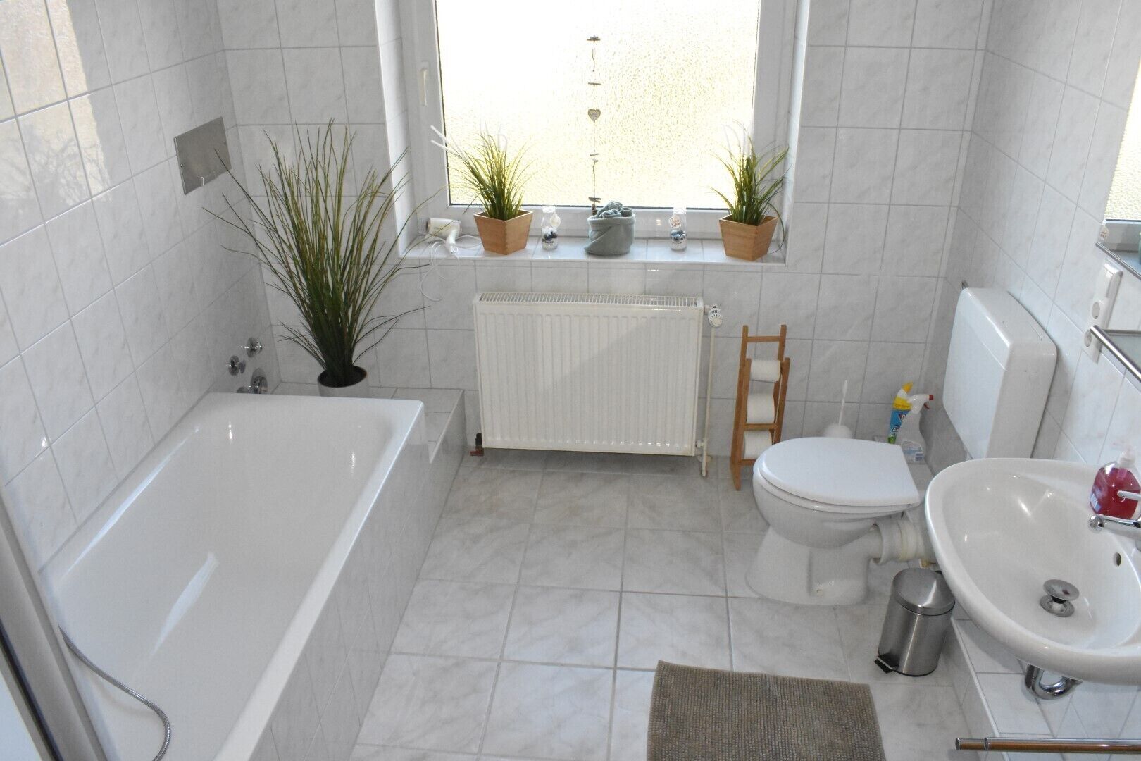 Bathtub, hair dryer, towels, toilet paper