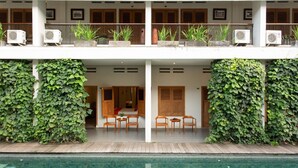 A hotel with a pool, covered outdoor seating, and air conditioning units. - Blambangan Hotel (Banyuwangi)