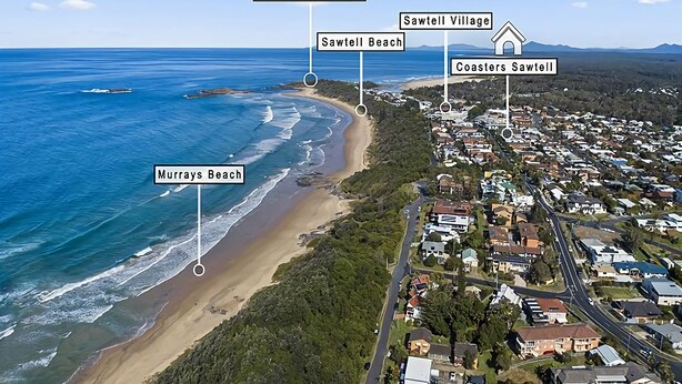 An aerial view of a coastal town with labeled beaches and residential areas.
