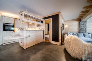 A rustic kitchen with wooden cabinetry and a built-in oven.