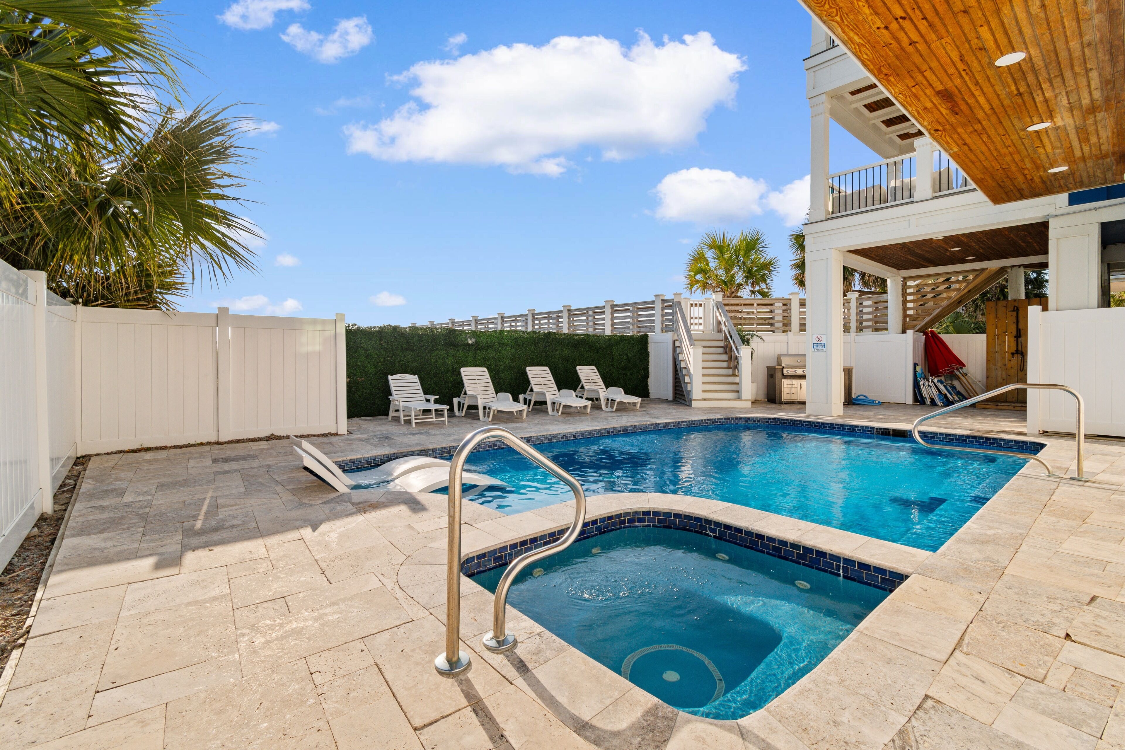 Private pool and spa surrounded by tropical palms in a coastal vacation home setting. Grill NOT included.