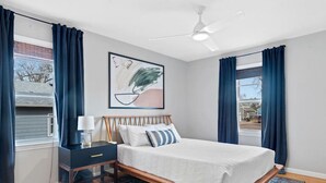 A bedroom with a bed, nightstand, and a ceiling fan. - Walk to Parks- Pet Friendly-Top Neighborhood (Rapid City)