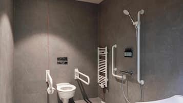 A modern bathroom with a toilet, a shower, and a bathtub.