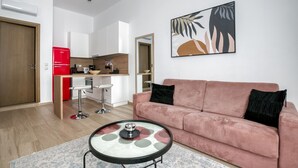 A modern apartment with a living room, kitchen, and dining area.