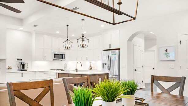 A modern kitchen with white cabinets, a central island, and pendant lighting. - ☀️Private Pool-Walk 2 Beach-Pearl Flamingo☀️ (Panama City Beach)