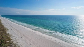 A beach with a long stretch of sandy shore and calm ocean waters. - ☀️Private Pool-Walk 2 Beach-Pearl Flamingo☀️ (Panama City Beach)
