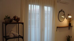 Ein Badezimmer mit einem Holzboden, der Handtücher, eine Topfpflanze und ein dekoratives Motorrad beherbergt.