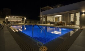 Relax by the pool surrounded by sleek architecture and comfortable seating.