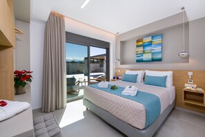 Relax in a spacious room with a large bed, sliding glass door to a mountain view, and a cozy reading nook.