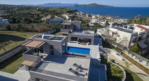 Enjoy panoramic views of the surrounding landscape and sea from the rooftop terrace, featuring a swimming pool.