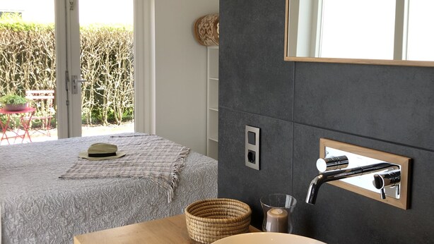 A modern bathroom with a large mirror, a vessel sink, and a wooden vanity. - RENOVATED vacation home by the sea Breskens10 pers. child friendly, dog welcome.  (Breskens)