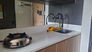 A modern kitchen with a stainless steel toaster, a sink, and a faucet.