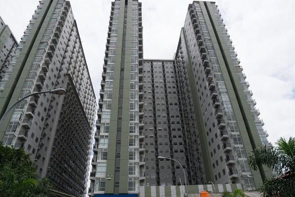 A high-rise building with multiple balconies and a uniform facade.