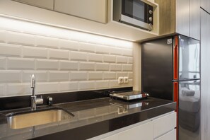 Room | Private kitchen | Fridge, stovetop, cookware/dishes/utensils - Stunning Studio at Ciputra World 2 Apartment (Jakarta)