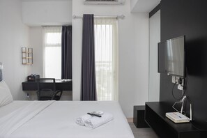 Enjoy a convenient stay with a neatly made bed, desk, and flat-screen TV.