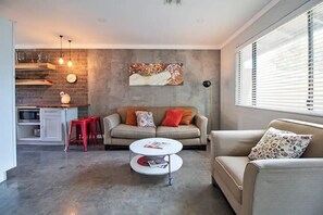 Relax in a cozy seating area with a sofa and side chairs, perfect for unwinding or socializing.