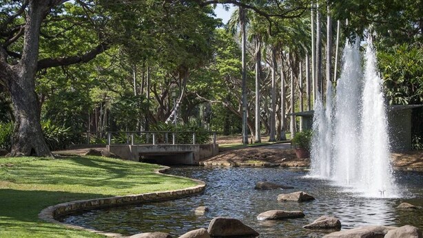 A serene park with a pond, a bridge, and a waterfall. - Zen City Balcony ~ Outdoor Dining ~ Mindal Markets (Larrakeyah)
